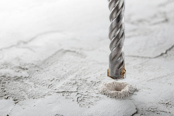 istock drill bit make holes in concrete wall with industrial drill. Building work industry. 1404046717