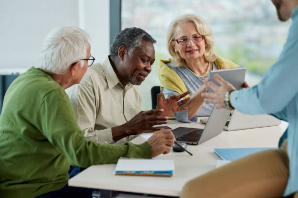 istock A young teacher is showing senior students how to solve an informatics problem on tablet. 1404048235