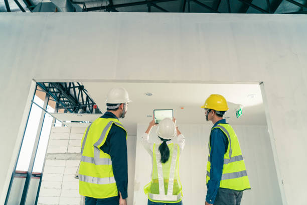 istock Behind Team Architect team building inspection with augmented reality application on digital tablet at construction site. 1404048914
