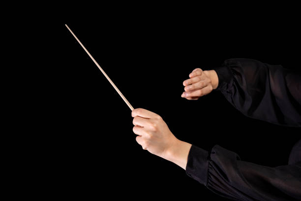 istock Female conductor conducting a symphony with her baton on a black background 1404049557