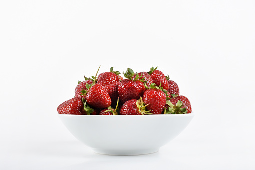 Strawberries in a bowl on the white background, bowl of strawberry