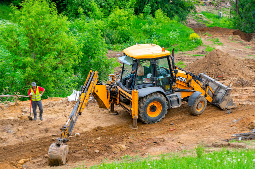 Moscow. Russia. 2022 June 12. The excavator digs the ground. Earthworks in the city.