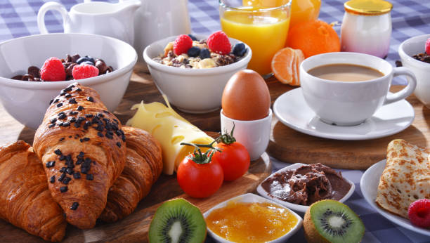 istock Breakfast served with coffee, juice, croissants and fruits 1404053285