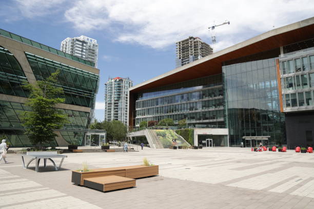 Surrey Civic Plaza, City Hall and Library, British Columbia, Canada Surrey, Canada - June 17, 2022: Surrey Civic Plaza offers a popular venue for festivals and other gatherings outside Surrey Library and Surrey City Hall. Modern residential buildings are under construction the Whalley neighborhood in the background. Spring midday in Metro Vancouver. surrey british columbia stock pictures, royalty-free photos & images
