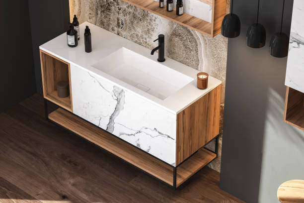 istock Close up of sink with square mirror standing in on marble wall, 1404053596