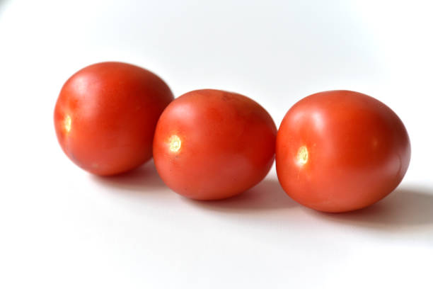 istock Ripe red tomatoes on a white background one and several 1404054535