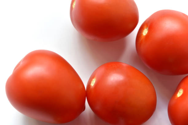 istock Ripe red tomatoes on a white background one and several 1404054552