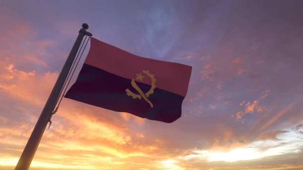 Angola Flag on Flagpole by Evening Sunset Sky stock photo