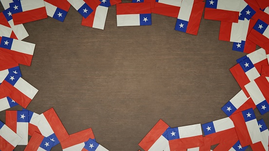 Frame made of paper flags of Chile arranged on wooden table. National celebration concept. 3D illustration