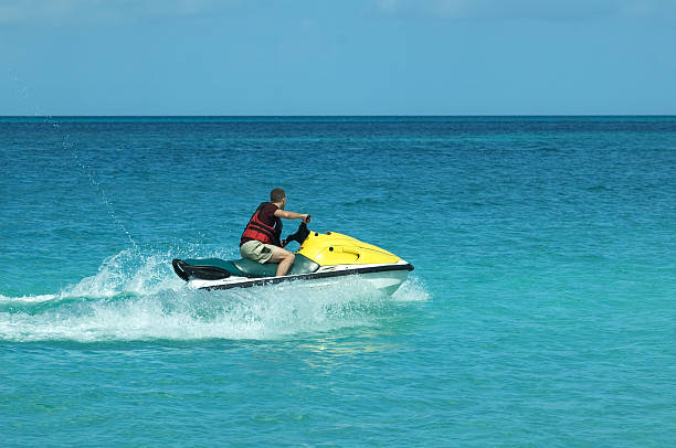 istock Lone man on a yellow jet ski in the ocean 140405800