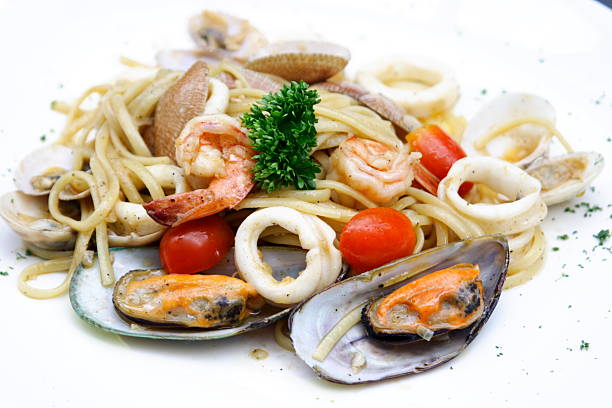 Pile of seafood pasta with clams shrimp squid and more stock photo