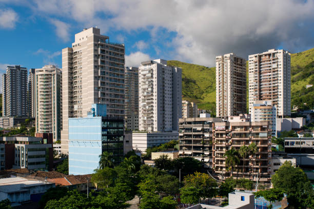 A lively streetscape in São Paulo showcasing diverse architectural styles and urban vibrancy. The composition highlights city buildings with varied facades, including modern and historical elements, under an overcast sky. A dynamic urban ambiance where commerce, culture, and history coexist. Ideal for themes of urban culture, metropolitan life, and South American cities.