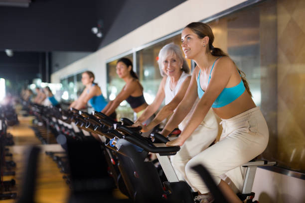 istock Young girl on training using bike in gym 1404060674