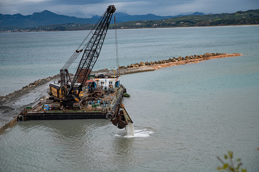 Construction Industry on Sea - Building in Progress of a Breakwater for protection of a New Tourist Harbor