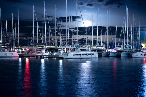 Evening Full Moon Rising over a Sailing Boats Marina in Greece