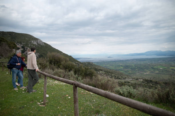 istock Three Mature Tourists Debating About Past and Next Road trip Route Locations Looking at View on a Panoramic Viewpoint in Greece 1404061265