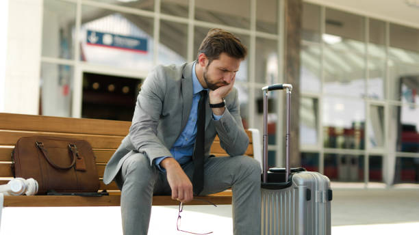 istock Pensive businessman is waiting at train station alone 1404061277