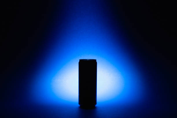 One aluminium cans on the blue background.Front view of one dark beverage drink cans on the bluebackground. Food and drink concept.