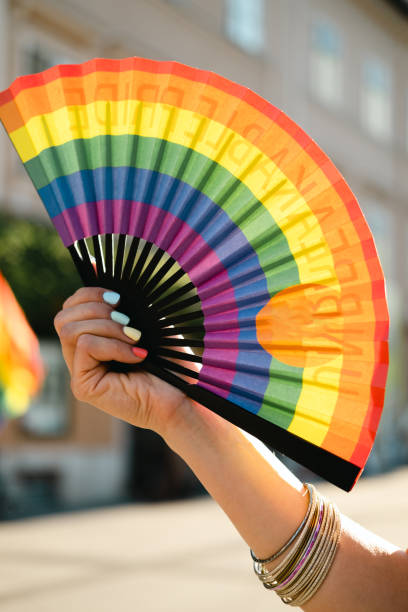 istock Hand fan in Pride colors. 1404064084