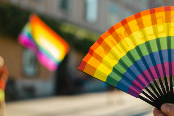 istock Hand fan in colors of rainbow. 1404064125