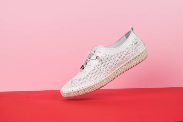 istock Levitating leather women's summer shoe on a red and pink background. 1404065493