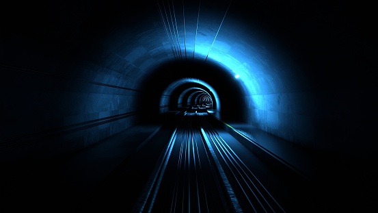 The train rides in subway. Driving through the illuminated tunnel. Underground.