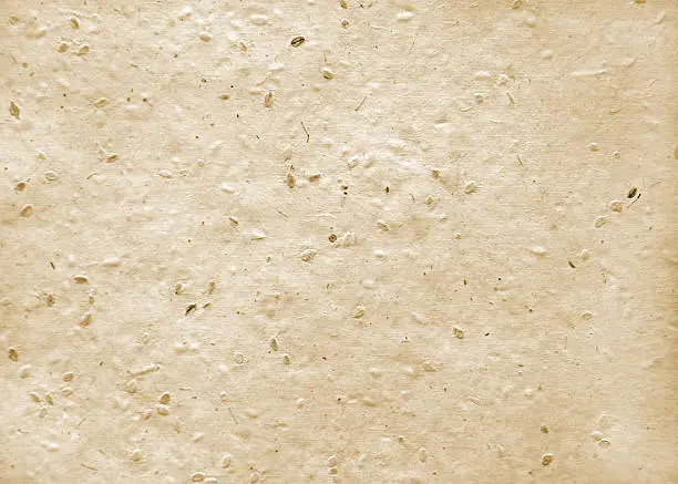Image of a sheet of handmade paper in neutral tones with a dimensional qualty.