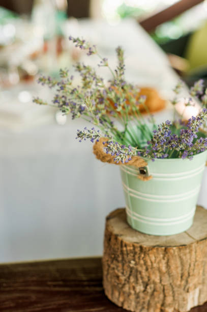 istock Natural lavender decoration at the dining table in a restaurant. Rustic decor. Vintage style. A bunch of lavender in a bucket 1404066664