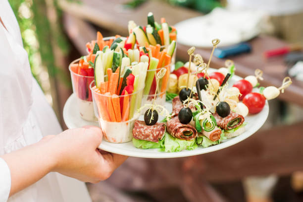 istock Vegetable and meat snacks on white plate. Healthy buffet. Home holiday celebration event. Dining table close up. Catering party 1404066667