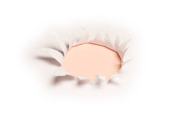 istock A hole in a white paper on a red background, copy space. 1404068979
