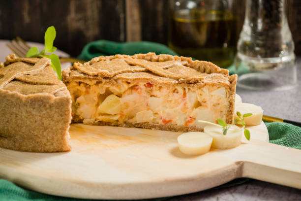 palm heart pie pie stuffed with hearts of palm, baked in the oven. on top of a rustic board palm heart photos stock pictures, royalty-free photos & images