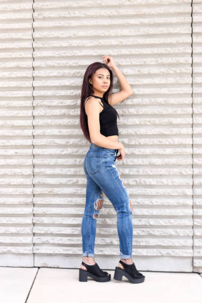 istock Girl posing with casual clothes on a wall 1404070543