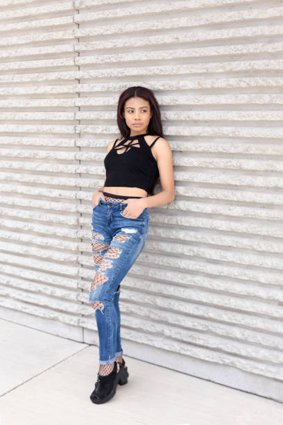 istock Girl posing with casual clothes on a wall 1404070559