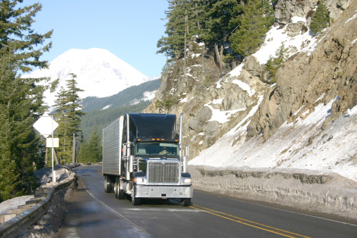 trucking through mountains (Mt. Rainer in Washington State in the background)