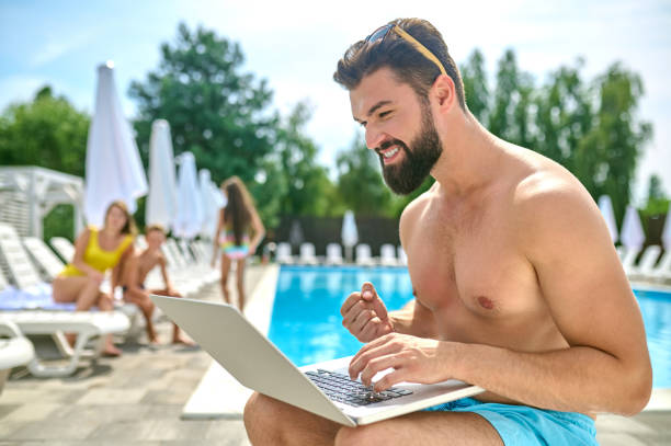 istock Male vacationer with his computer at the resort 1404073090