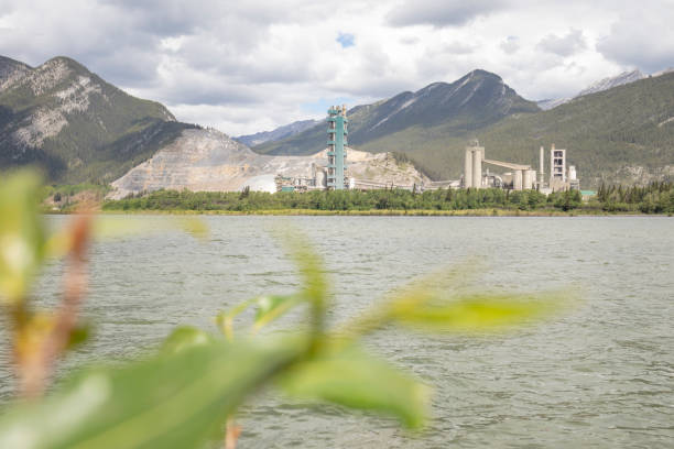 istock View of cement  plant in mountain setting, leaf interference and lake in foreground 1404074228