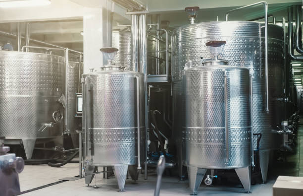 istock Typical steel barrels for wine fermentation in winery factory 1404075516