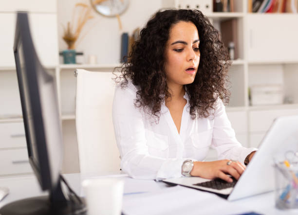 istock Office woman worker is working with documents and laptop in office 1404075611