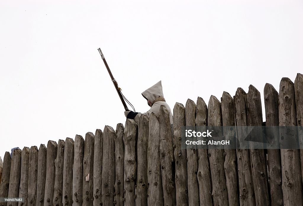 Standing Guard Man in a fort with a musket Fence Stock Photo