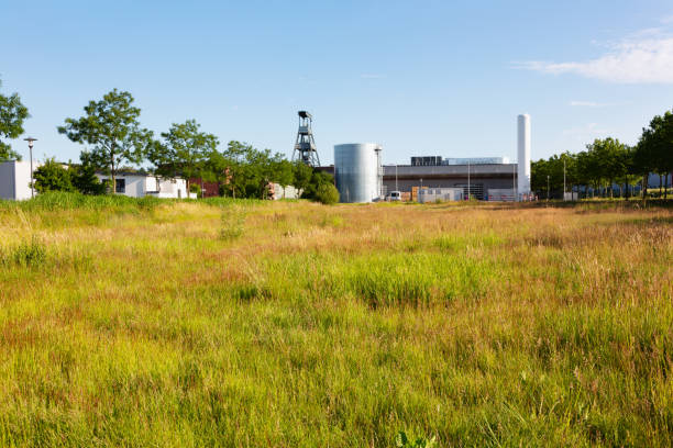 istock summer meadow and industrial buildings 1404077097