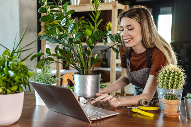 istock Beautiful woman looking online tutorial about gardening 1404077792