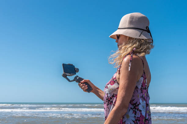 istock Woman taking a selfie on the beach 1404078776