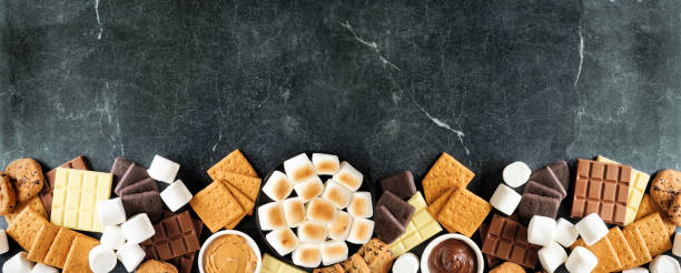 Smores buffet bottom border over a dark stone background