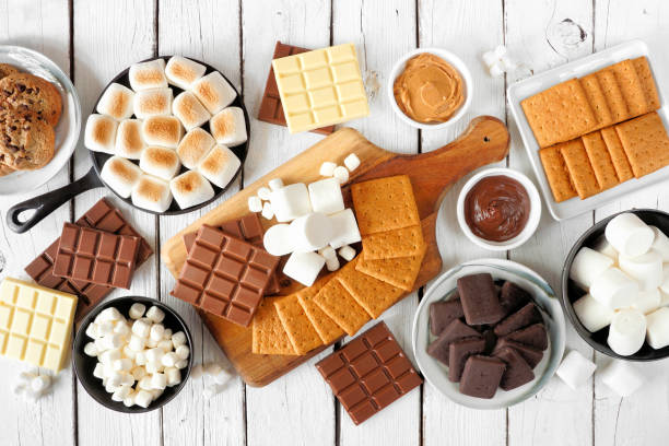 istock Smores buffet table scene, top view over a white wood background 1404079048