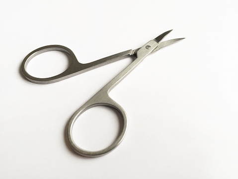 Manicure scissors on the white background