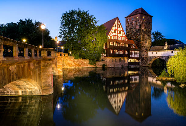 Nuremberg old city houses on riverside of Pegnitz river from Maxbrucke (Max bridge)\nNuremberg, Franconia, Bavaria, Germany\n\nThe Weinstadel, built in the 15th century