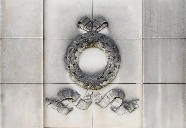 Grave detail showing a laurel-wreath          
