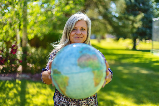 Colorado West Outdoor Mature Adult Female Holding a Earth Globe Living the Future of Earth Photo Series