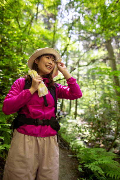 istock Female hiker wiping sweat in forest 1404081103