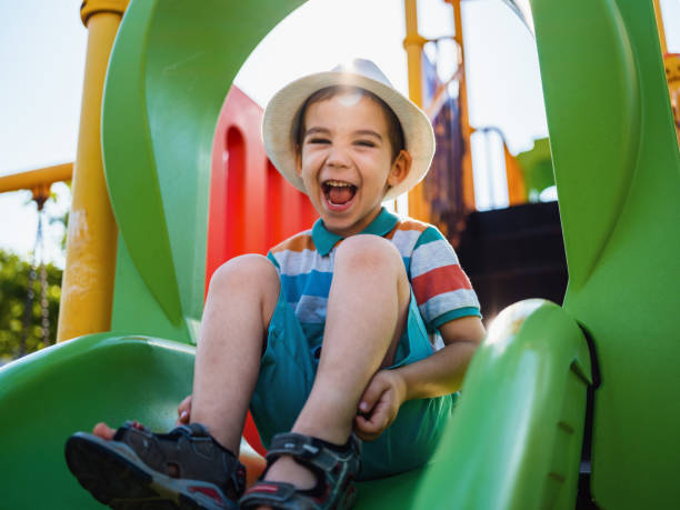 istock Happy Little Child Boy Playing Outdoors At Playground 1404081182